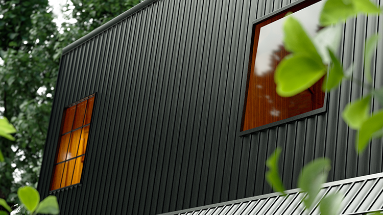 Black board and batten metal siding is used on this metal building