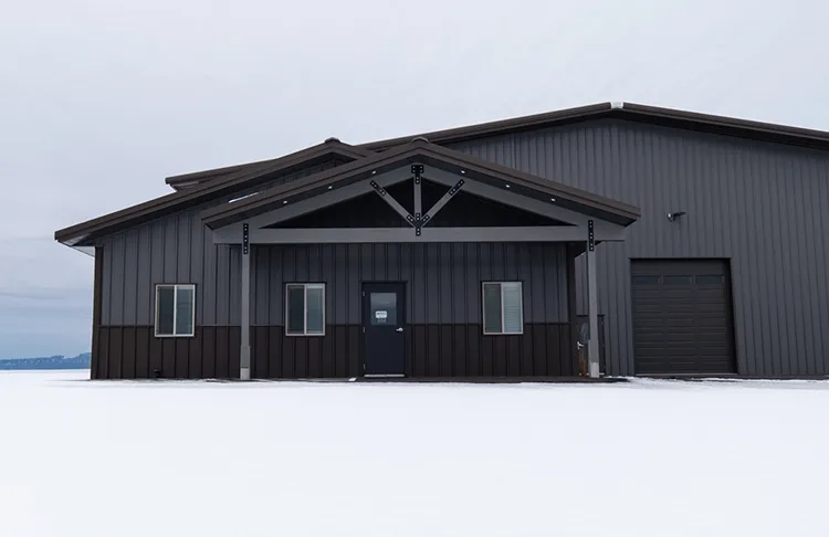A contractor shop features dark roofing and siding panels
