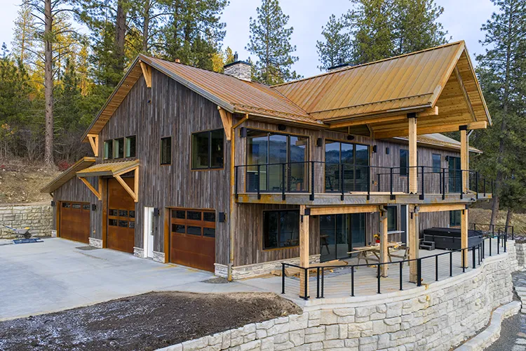 A house using wood look metal siding and cor-ten roofing panels