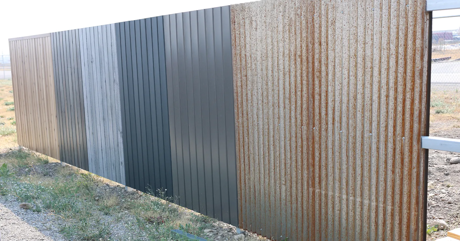 Metal fencing in a variety of wood look finishes on display outside of metal america