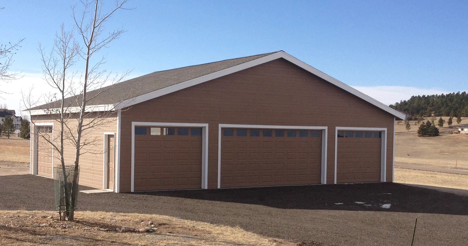A garage with brown metal shiplap siding