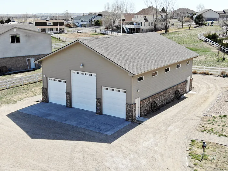 This beige polebarn has metal shiplap siding