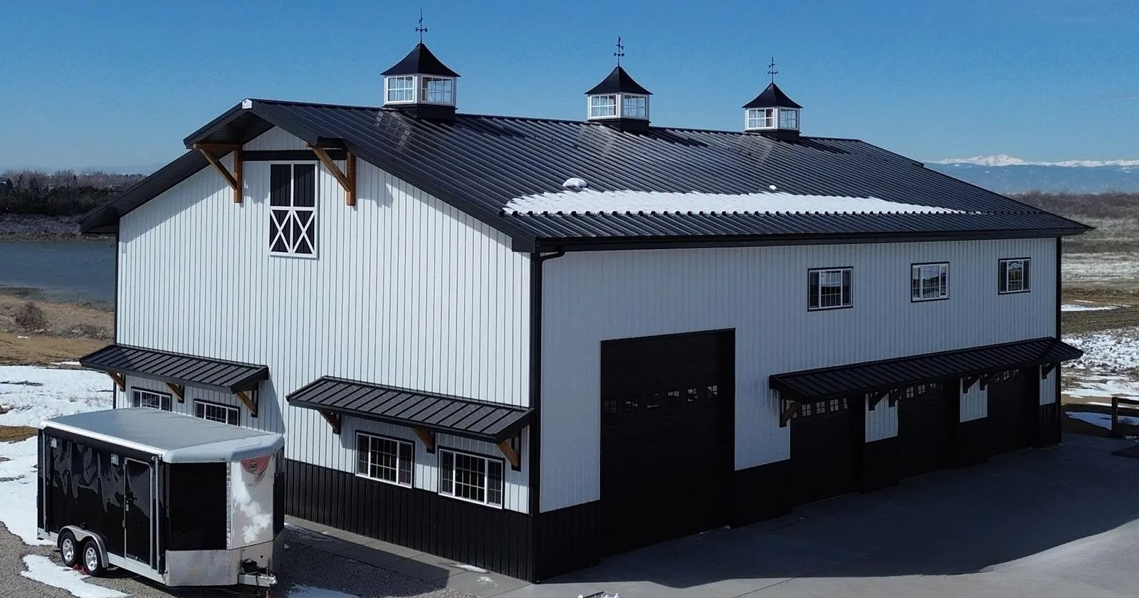 A modern farmhouse with white metal siding