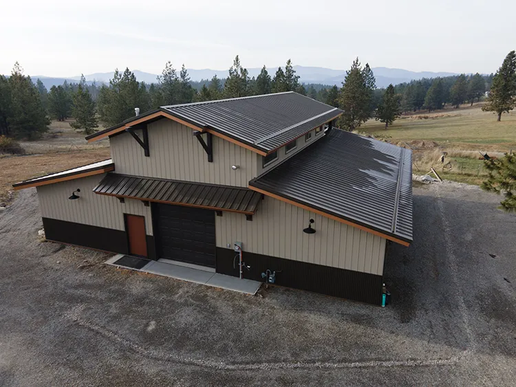 A barndominium with brown and tan metal siding