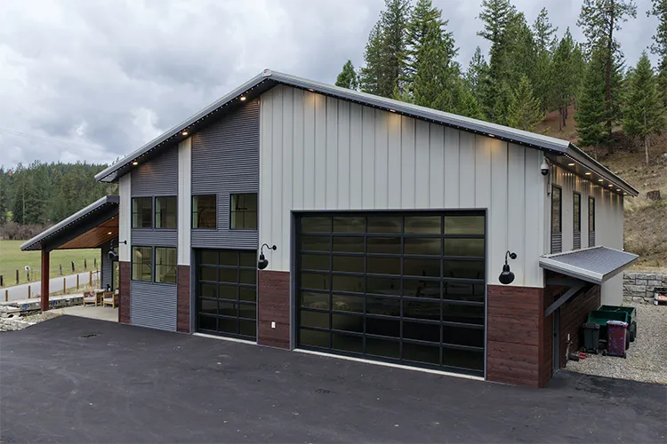 A barndominium feature board and batten, corrugated, and flush steel siding panels