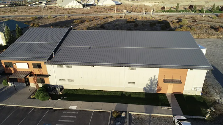 A commercial service building with black metal roofing