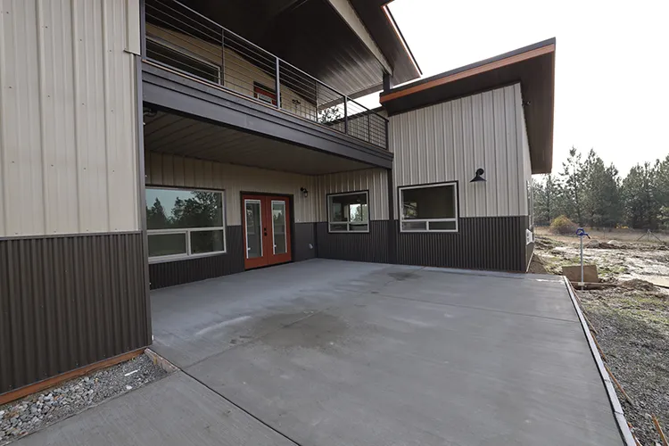 This farmhouse is tan with a deep brown wainscott