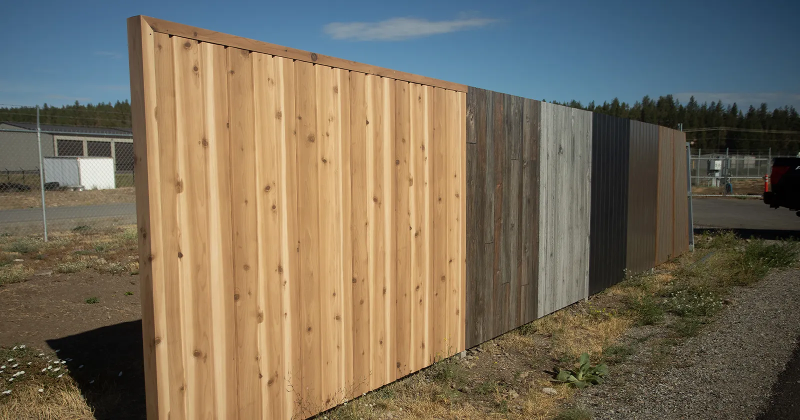 A selection of fireproof metal fencing section with different wood look finishes