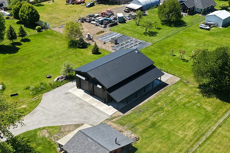 metal roof maintenance is critical for this shop with a black metal roof