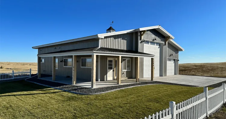 A corner view of a modern farmhouse with grey metal siding, the kind of exterior vertical metal siding suits