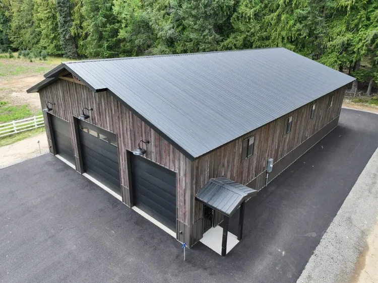 Charcoal gray and black metal roof finishes on residential homes showing dark color durability