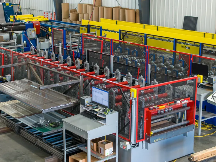 Galvalume steel being roll-formed into panels, a material that fits the meaning of non combustible