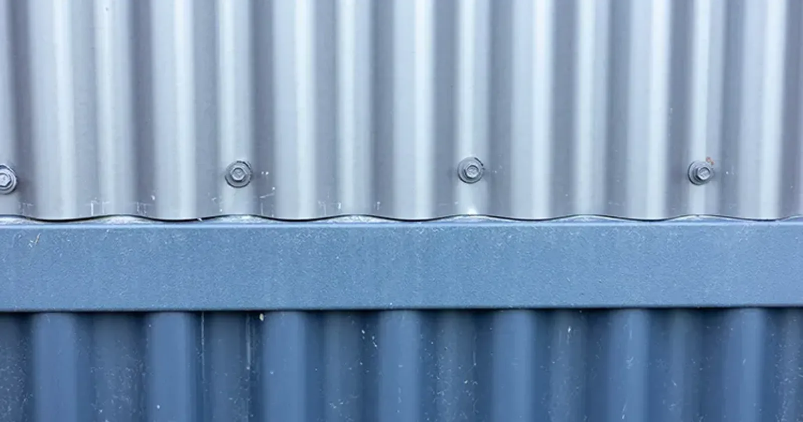 Corrugated metal siding on a commercial building, showing the classic wavy corrugated metal profile