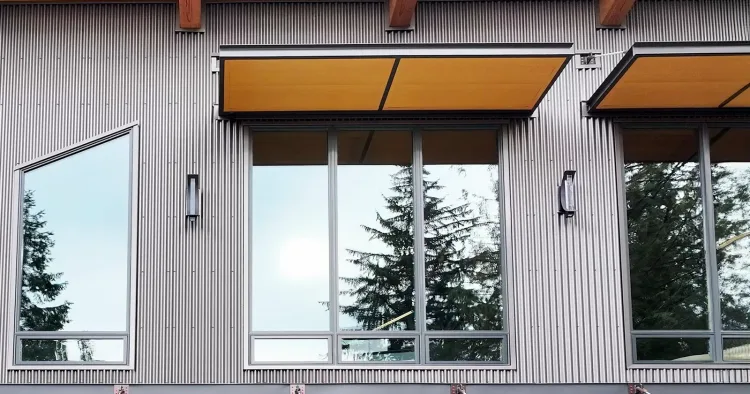 Corrugated steel siding panels on a finished building, cladding suited to a non combustible construction type