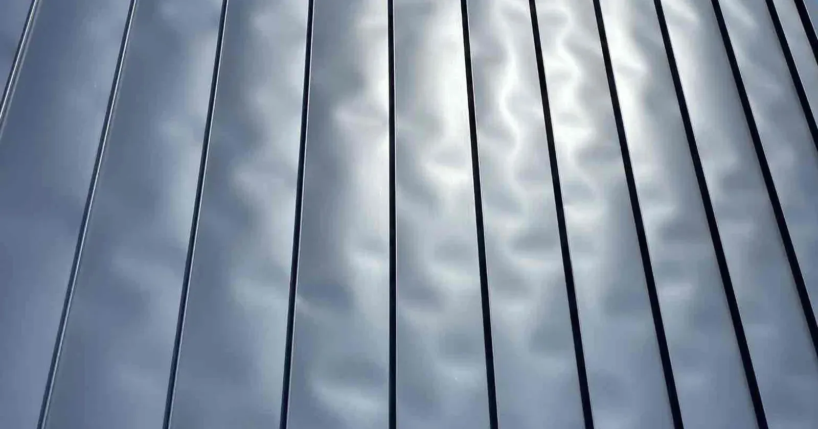 A closeup of oil canning on a metal roof
