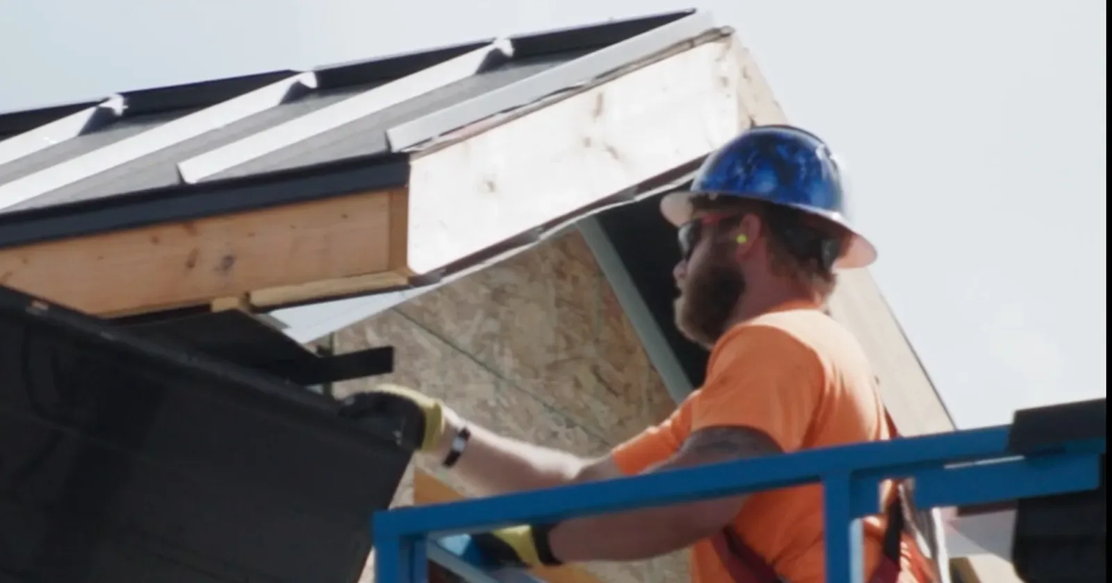 Workers installing metal roofing panels, the kind of crew steel roofing contractors near me should field