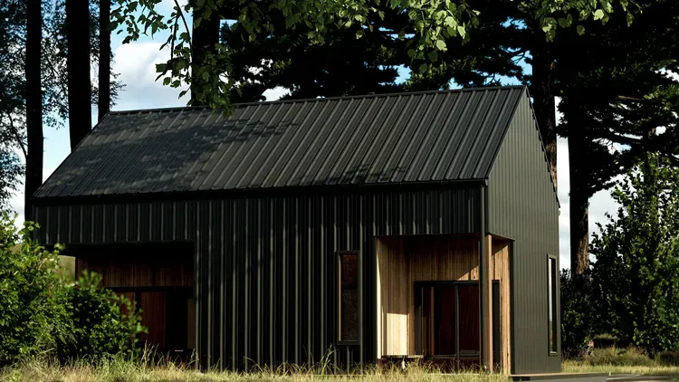 Standing seam and exposed fastener metal panels side by side, showing which profiles show oil canning