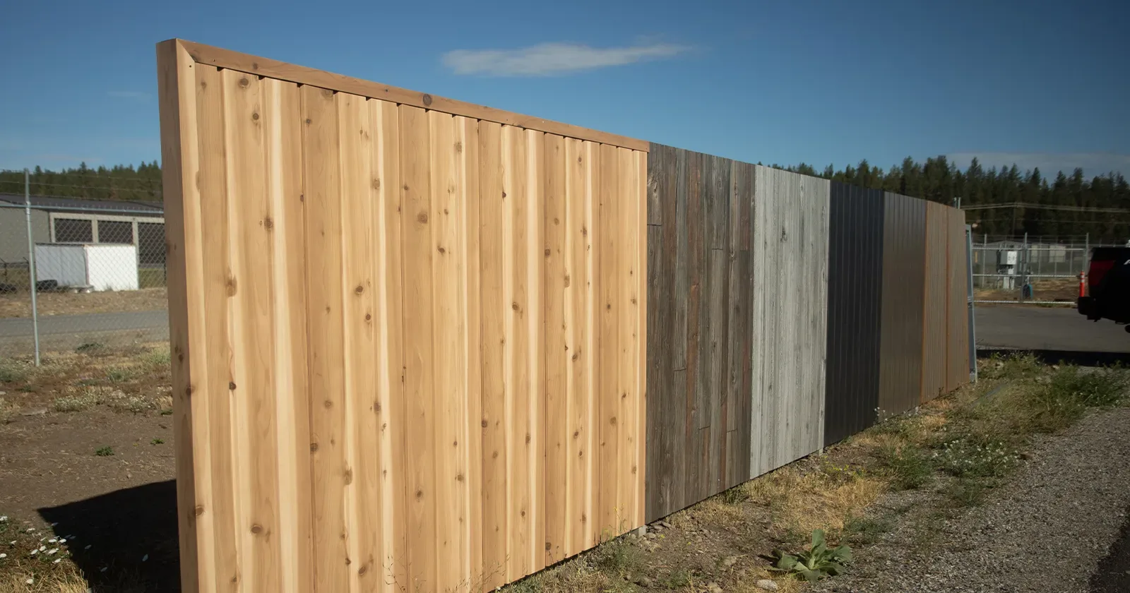 Wood grain steel fence panels shown side by side, a non combustible fence option for wildfire country