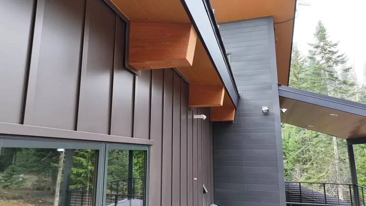 A modern farmhouse with grey metal siding, the look driving metal board and batten siding near me searches