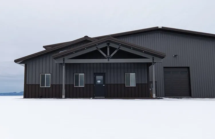 A shop with coordinated black roofing and siding, metal roofing panels for pole barn workshop use