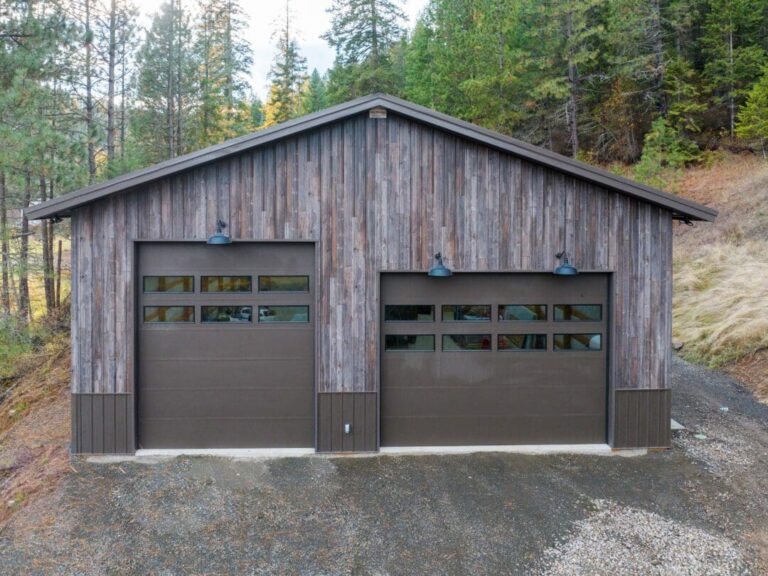 Barnwood metal siding with Burnished Slate trim around two overhead doors