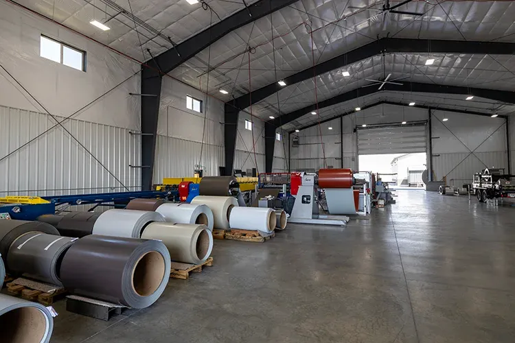 Coils of painted steel at Metal America, the stock a metal roofing supplier in Idaho roll-forms into panels