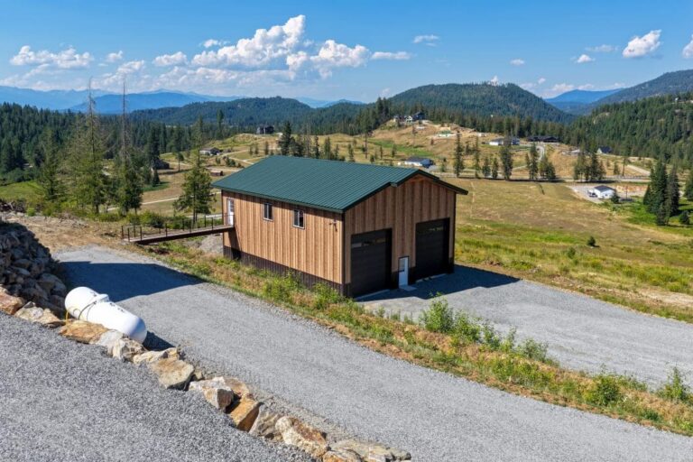 Smooth Cedar steel shop with Fern Green roof and mountain views in North Idaho